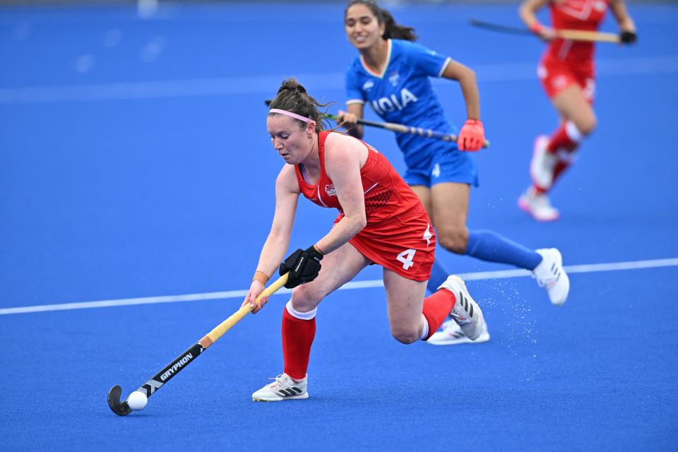 Englands Laura Unsworth (L) hits the ball during the Womens hockey match between England and India on day five of the Commonwealth Games at the University of Birmingham Hockey and Squash Centre in Birmingham, central England, on August 2, 2022. (Photo by GLYN KIRK / AFP) (Photo by GLYN KIRK/AFP via Getty Images)