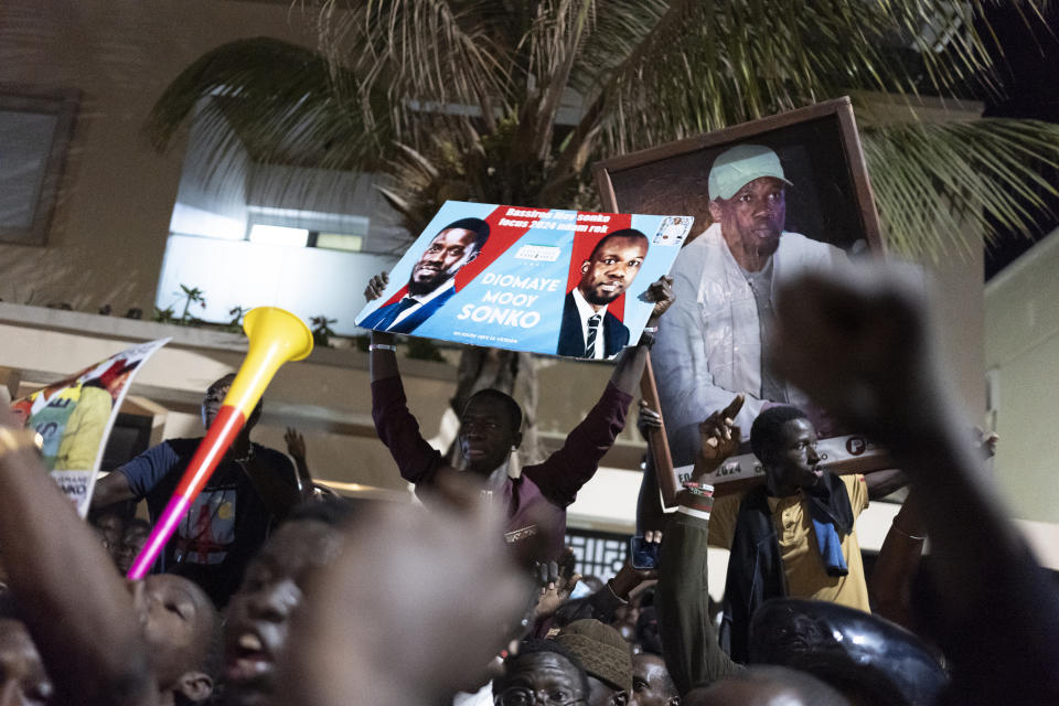 Supporters celebrate the release of Senegal's top opposition leader Ousmane Sonko and his key ally Bassirou Diomaye Faye outside Sonko's home in Dakar, Senegal, Thursday, March 14, 2024. Sonko had been in prison since July 2023 and has fought a prolonged legal battle to run for president in the March 24 election.(AP Photo/Sylvain Cherkaoui)