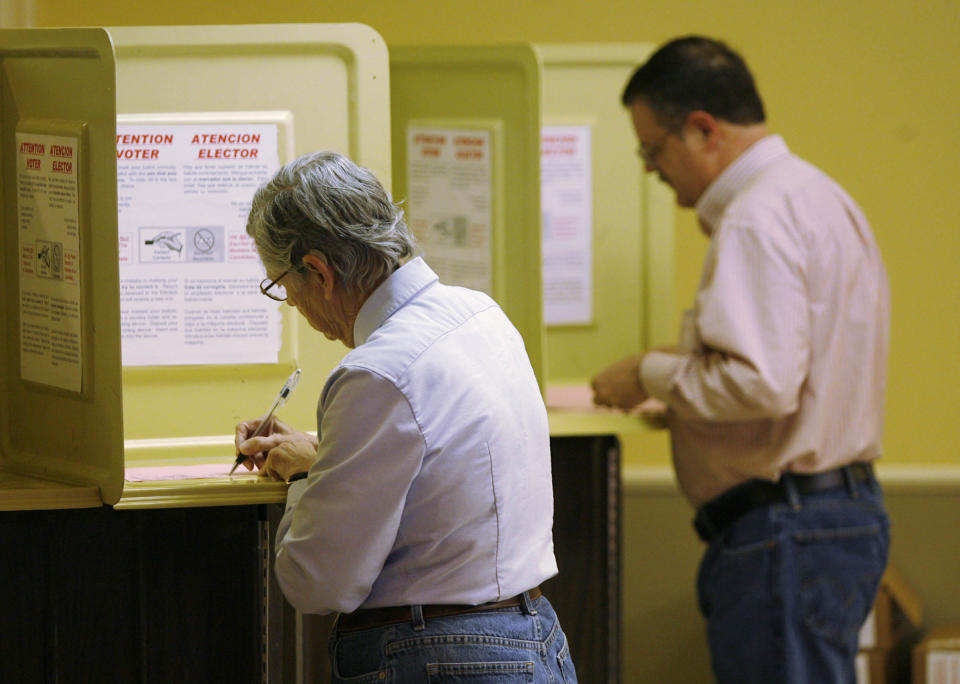 Voters fill out their ballots for the Republican presidential primary at the Faith Assembly church in Tulsa, Okla. on Tuesday, March 6, 2012. (AP Photo/The World,Matt Barnard) TV OUT; TULSA OUT