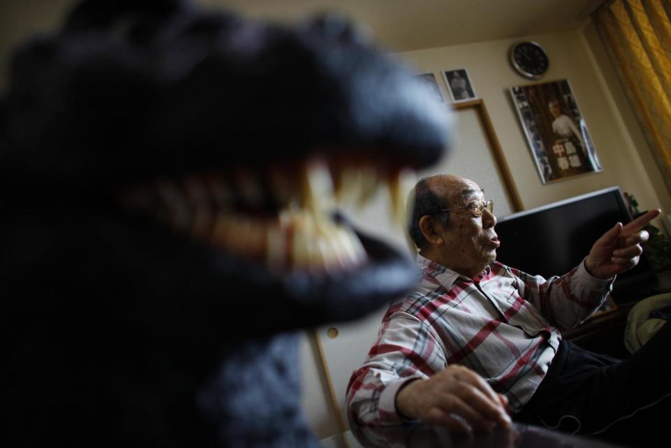 In this Monday, April 28, 2014 photo, original Godzilla suit actor Haruo Nakajima, who has played his role as the monster, speaks during an interview at his home in Sagamihara, near Tokyo. Nakajima, 85, was a stunt actor in samurai films, when he was approached to take the Godzilla role. He had to invent the character from scratch, and went to the zoo to study the way elephants and bears moved. (AP Photo/Junji Kurokawa)