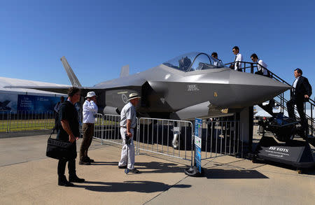 Visitors inspect a Lockheed Martin Corp F-35 stealth fighter jet on display at the Avalon Airshow in Victoria, Australia, March 3, 2017. AAP/Tracey Nearmy/via REUTERS