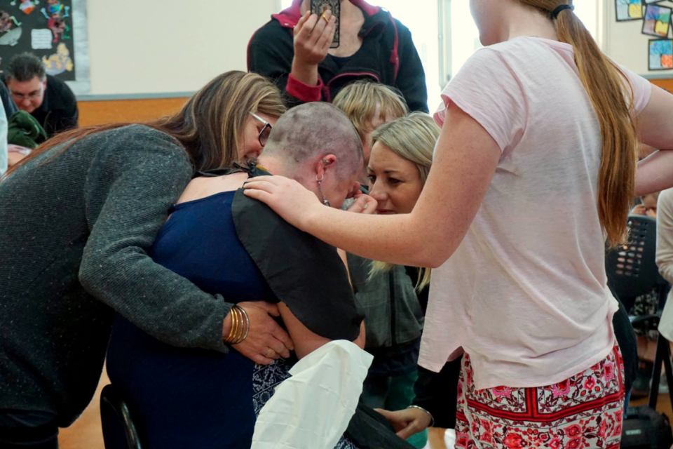 An emotional Proebstel after shaving her head. Image via Facebook. 