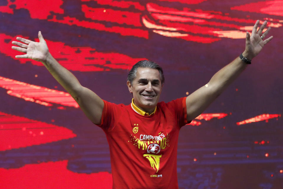 Head coach Sergio Scariolo of Spain celebrates with his players from Spain's national basketball team in front of fans in Madrid, Spain, Monday, Sept. 16, 2019. Spain has captured its second World Cup championship, defeating Argentina 95-75 on Sunday. (AP Photo/Bernat Armangue)