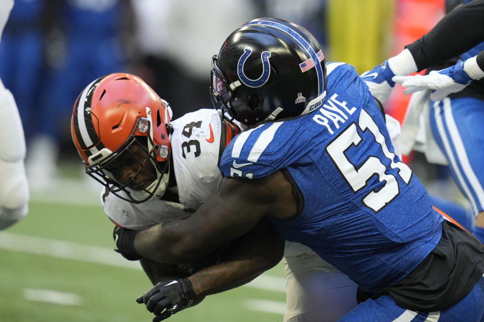 Cleveland Browns running back Jerome Ford (34) is tackled by Indianapolis Colts defensive end Kwity Paye (51) during the first half of an NFL football game, Sunday, Oct. 22, 2023, in Indianapolis. (AP Photo/Michael Conroy)