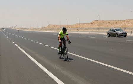 Egyptian cyclist Helmy El Saeed, 27, rides his bicycle during training on the highway of El Ain El Sokhna, east of Cairo, Egypt July 19, 2017. REUTERS/Amr Abdallah Dalsh