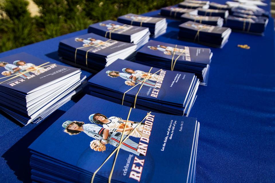 Booklets with photos of Rex and Brody Reinhart are seen at the brothers' celebration of life service at the Florida Ballpark on Monday, May 17, 2021, in Gainesville, Fla.