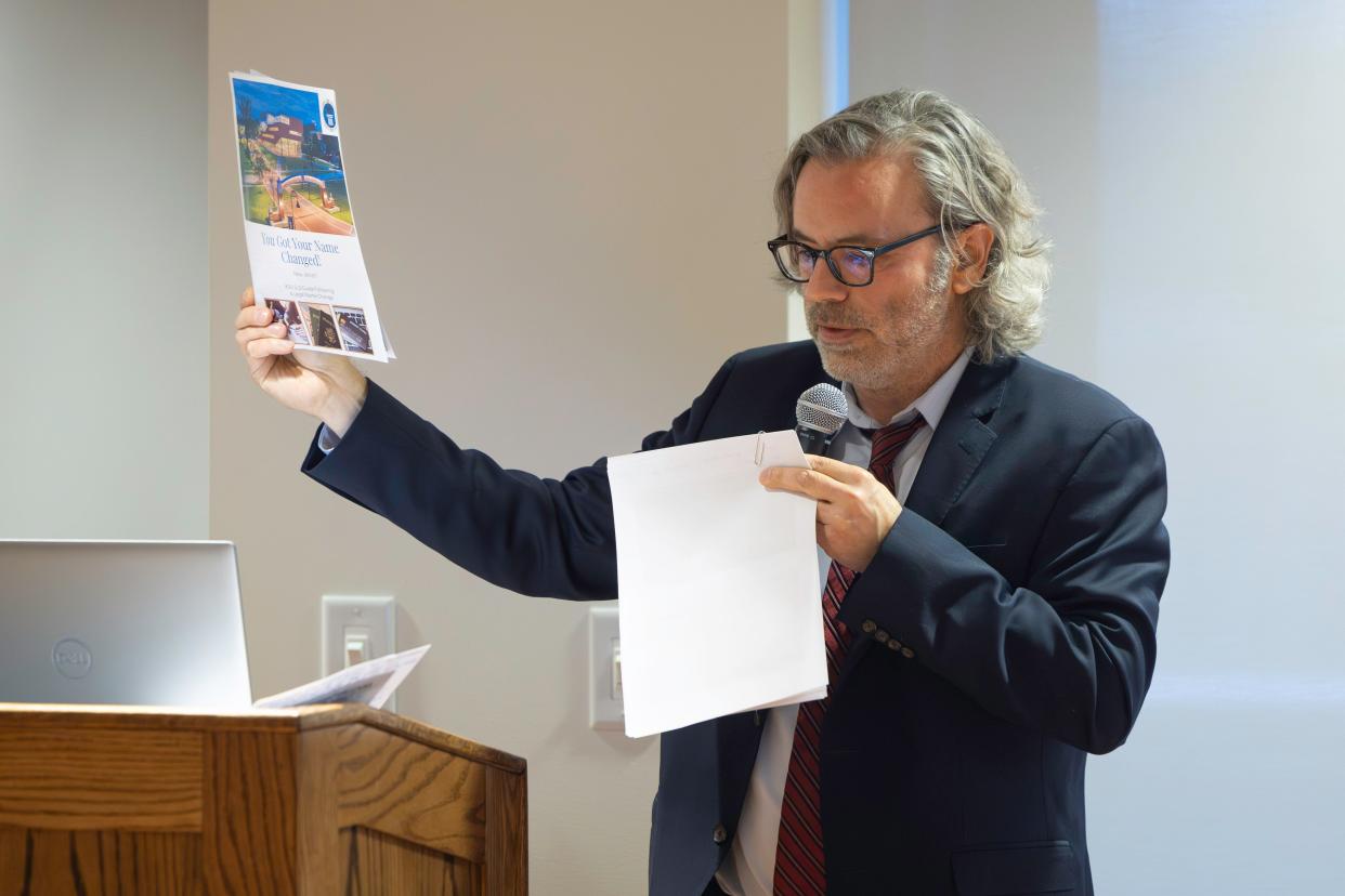Kent State Student Legal Services attorney Chris Sestak holds up an example of a resource pamphlet to help in the process of legally changing your name during a clinic presented in conjunction with the LGBTQ+ Center on campus Thursday, Jan. 30, 2024.