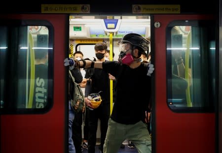 Protest at Yuen Long MTR station, the scene of an attack by suspected triad gang members a month ago, in Hong Kong