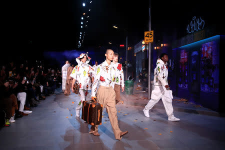 Models present creations by designer Virgil Abloh as part of his Fall/Winter 2019-2020 collection show for fashion house Louis Vuitton during Men's Fashion Week in Paris, France, January 17, 2019. REUTERS/Gonzalo Fuentes