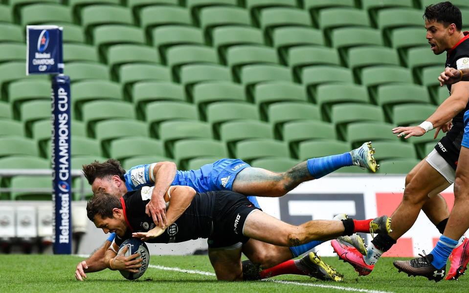 Alex Goode of Saracens dives over to score his side's first try despite the tackle of Hugo Keenan  - GETTY IMAGES