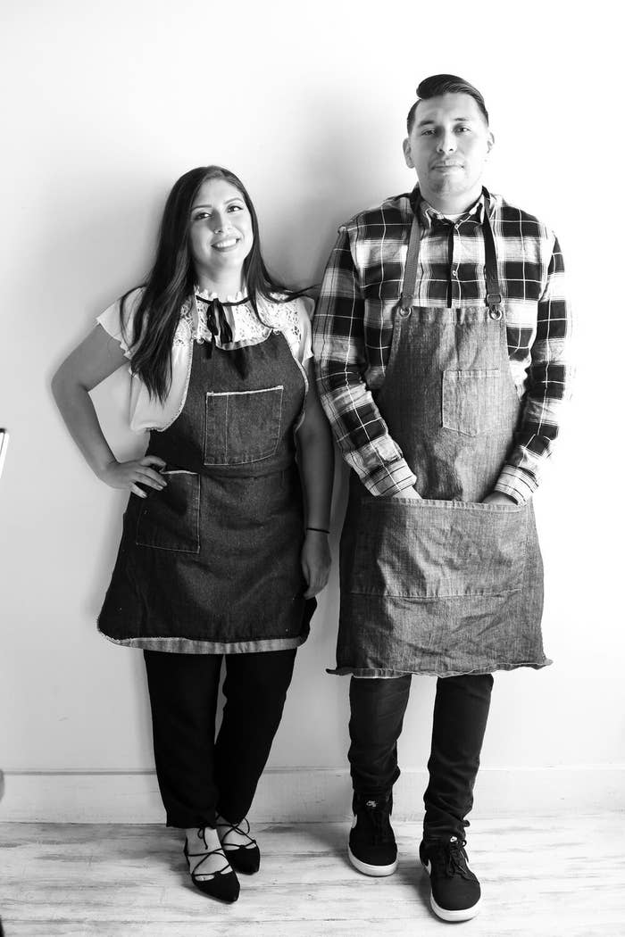 Black and white portrait of the Metztli Taqueria owners wearing aprons.