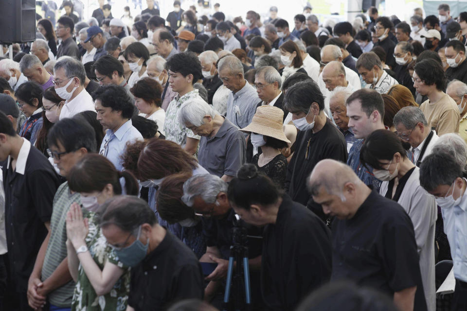 Attendees pray during a memorial ceremony for all war dead in Okinawa at the Peace Memorial Park in Itoman, Okinawa prefecture, southern Japan Friday, June 23, 2023. Japan marked the Battle of Okinawa, one of the bloodiest battles of World War II fought on the southern Japanese island, which ended 78 years ago. (Kyodo News via AP)
