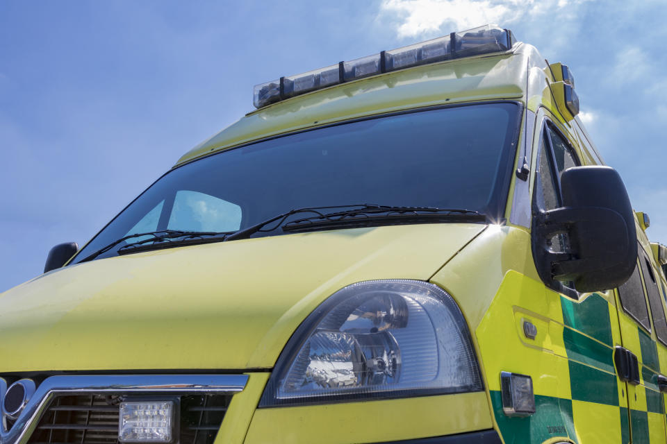 Yellow and green British Ambulance on a sunny day