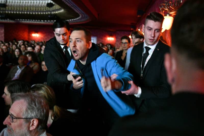 A man in the audience disrupts the event while Hillary Clinton is in conversation at the Cinema for Peace "Special Evening with Hillary Clinton" at the Theater des Westens. Sebastian Christoph Gollnow/dpa