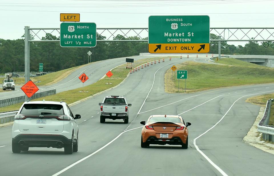 Traffic travels along Military Cutoff Road extension, which opened Thursday, after five years of construction. KEN BLEVINS/STARNEWS