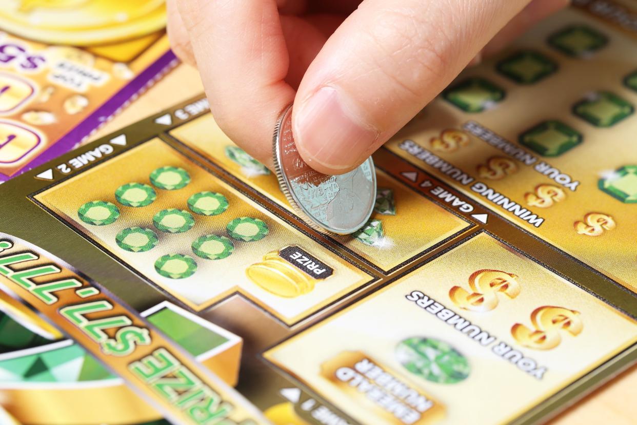 woman scratching lottery ticket