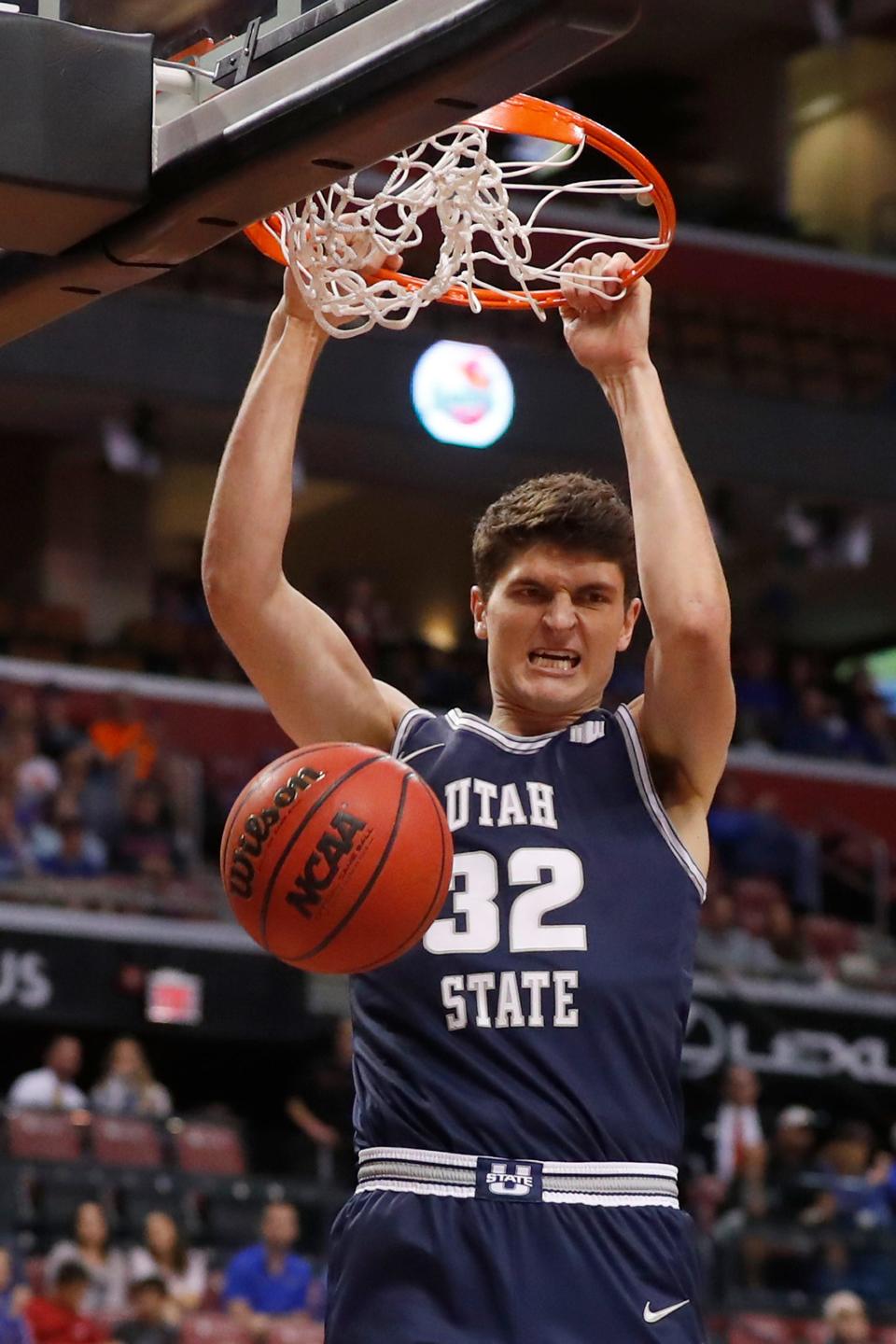 Utah State center Trevin Dorius dunks the ball in the first half of an NCAA college basketball game against Florida, part of the Orange Bowl Classic tournament, Saturday, Dec. 21, 2019, in Sunrise, Fla. (AP Photo/Wilfredo Lee)