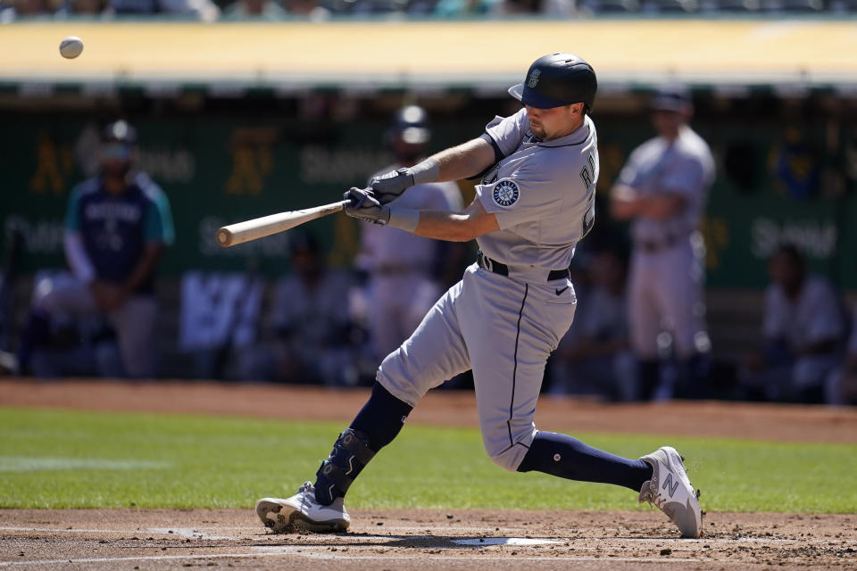 Seattle Mariners' Cal Raleigh hits an RBI double against the Oakland Athletics during the first inning of a baseball game in Oakland, Calif., Thursday, Sept. 22, 2022. (AP Photo/Jeff Chiu)