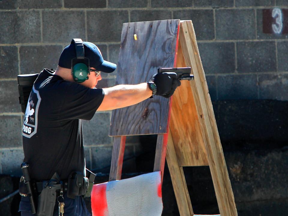 A police officer shoots a pistol during a police training exercise at the Eagle Creek Firearms Training Facility in Findlay, Ohio (AP)