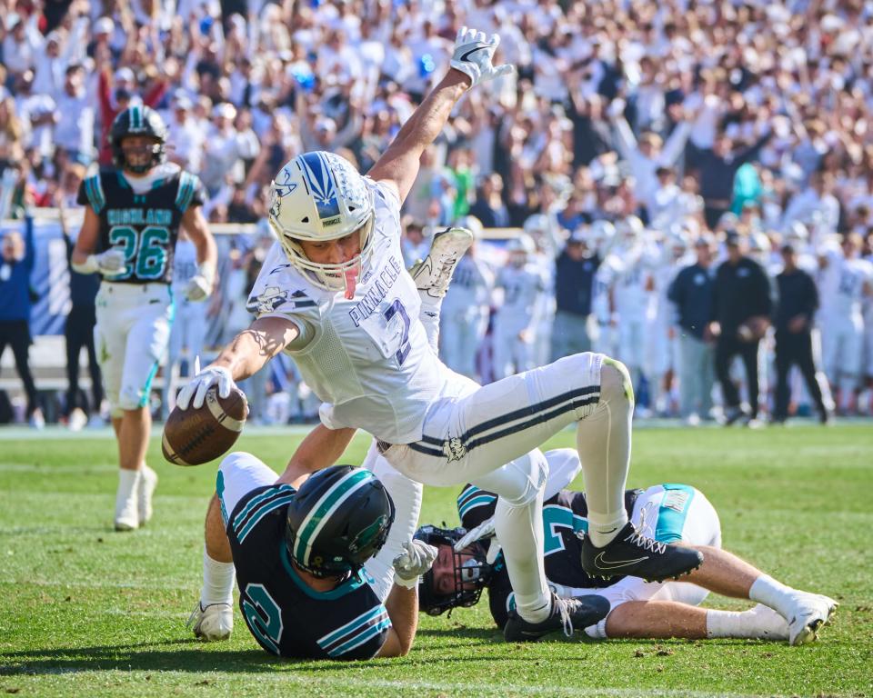 Dec 10, 2022; Tempe, AZ, USA; Pinnacle Pioneers wide receiver Duce Robinson (2) reaches for the end zone as he is brought the Highland Hawks during the 6A state championship game at Sun Devil Stadium in Tempe on Saturday, Sept. 10, 2022. Mandatory Credit: Alex Gould/The Republic