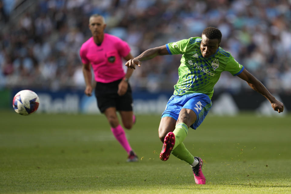 Seattle Sounders defender Nouhou Tolo, right, passes during the second half of an MLS soccer match against Minnesota United, Sunday, Aug. 27, 2023, in St. Paul, Minn. (AP Photo/Abbie Parr)