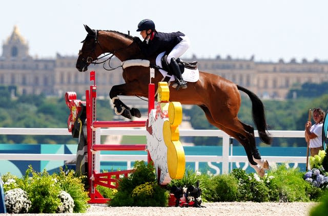 Laura Collett on London 52 taking off to jump a fence at the evening individual event at the Paris Olympics. 