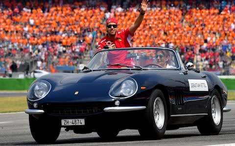 Ferrari's German driver Sebastian Vettel waves during the drivers parade ahead the German Formula One Grand Prix at the Hockenheimring racing circuit on July 22, 2018 in Hockenheim, southern Germany. - Credit: afp