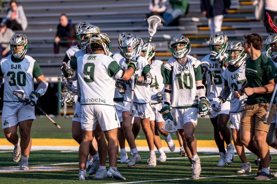 St. Jospeh players celebrate their 7-6 win. St. Joseph Regional High School lacrosse hosts Ramapo in Montvale, NJ on Wednesday, April 26, 2023. 