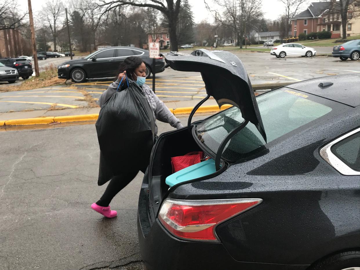 Jada Stewart, a junior at Albion College, loads her belongings into her mother's car on Nov. 15 as she moves back to her home in Chicago.