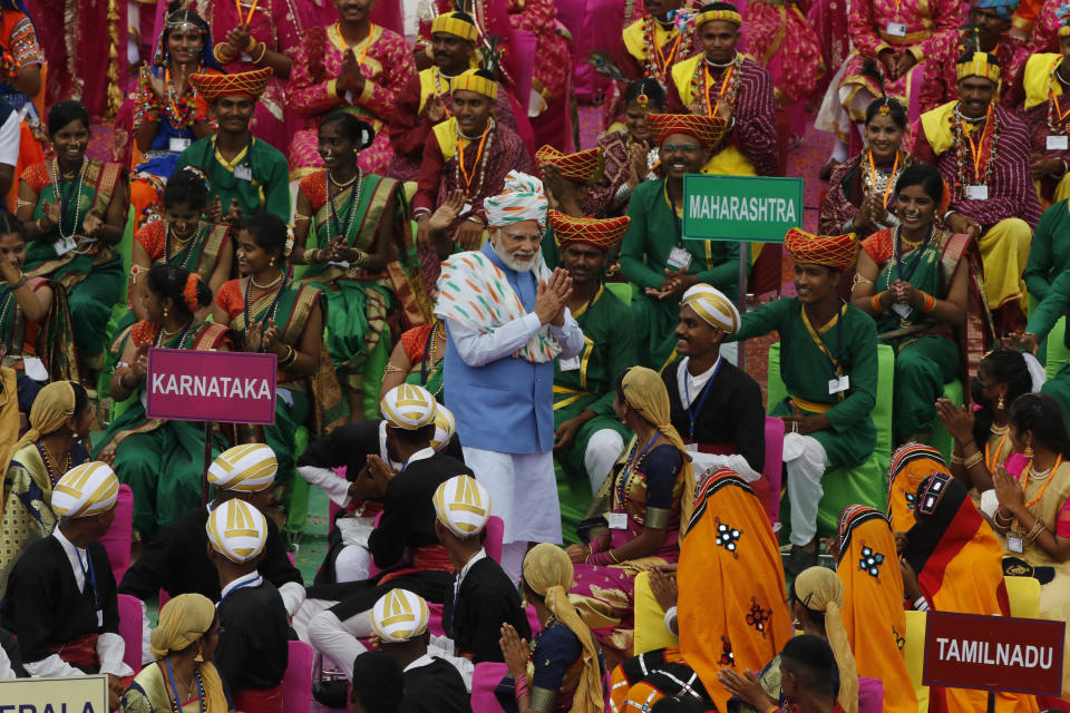 Indian Prime Minister Narendra Modi, center, greets artists performing at the 17th-century Mughal-era Red Fort on Independence Day in New Delhi, India, Monday, Aug.15, 2022. The country is marking the 75th anniversary of its independence from British rule. (AP Photo/Pankaj Nangia)