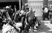 <p>Rev. Ralph Abernathy, left, and Rev. Martin Luther King Jr., right are taken by a policeman as they led a line of demonstrators into the business section of Birmingham, Ala., on April 12, 1963. (AP Photo) </p>