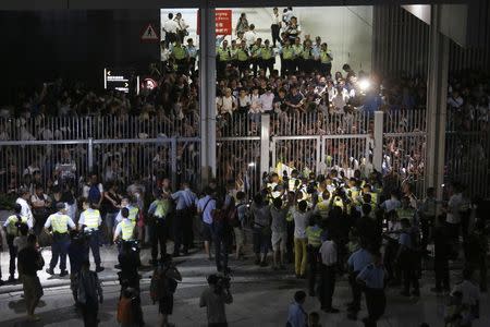 Protesters are surrounded by the police after hundreds stormed into a restricted area at the government headquarters, after a rally ahead of the October 1 "Occupy Central" civil disobedience movement in Hong Kong September 26, 2014. REUTERS/Bobby Yip