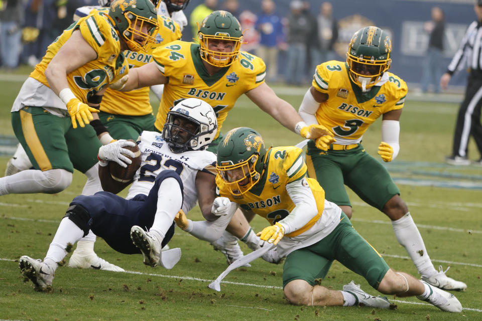 North Dakota State safety Dawson Weber (2) stops Montana State running back Isaiah Ifanse (22) during the first half of the FCS Championship NCAA college football game in Frisco, Texas, Saturday, Jan. 8, 2022. Helping to defend in the player are defensive end Brayden Thomas (98), defensive tackle Costner Ching (94) and linebacker Jasir Cox (3). (AP Photo/Michael Ainsworth)