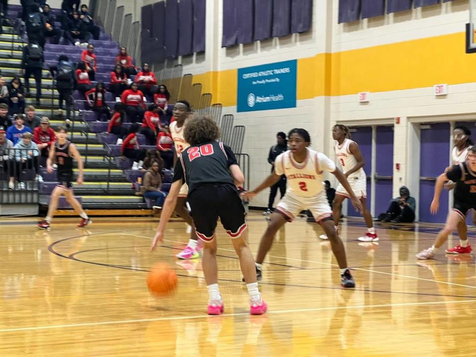 Nation Ford’s Chase Walters (black, 20) is trying to run the offense while being guarded by South Pointe’s Richard Pickering (2, white) in the second half of Nation Ford’s 60-56 win on Dec. 2 at the Battle of the Rock basketball showcase.