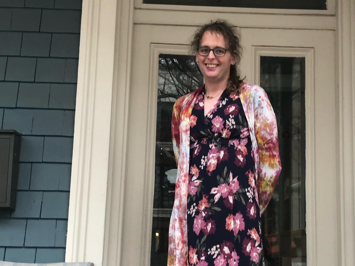 Thea Canby in a dress on a front porch