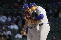 Los Angeles Dodgers starting pitcher Trevor Bauer, left, talks with shortstop Corey Seager during the third inning of a baseball game against the Chicago Cubs Tuesday, May 4, 2021, in Chicago. (AP Photo/Charles Rex Arbogast)