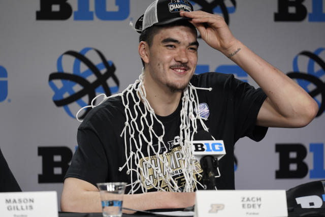 FILE - Purdue's Zach Edey wears the net around his neck during a news conference after his team's 67-65 win over Penn State to claim the Big Ten tournament championship in an NCAA college basketball game Sunday, March 12, 2023, in Chicago. Edey was honored Friday, March 31, 2023, as The Associated Press men's college basketball Player of the Year. (AP Photo/Erin Hooley, File)