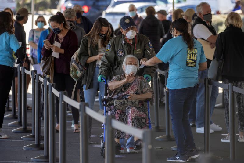 FILE PHOTO: People wait in line to be vaccinated in California