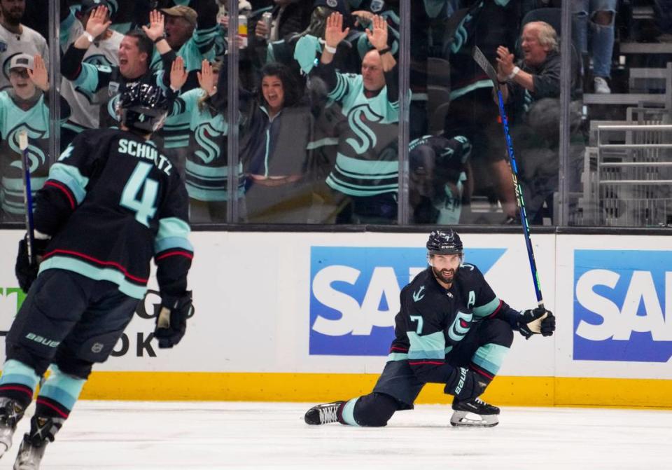 Seattle Kraken right wing Jordan Eberle (7) reacts after scoring against the Dallas Stars as teammate Justin Schultz (4) looks on during the second period of Game 3 of an NHL hockey Stanley Cup second-round playoff series Sunday, May 7, 2023, in Seattle. (AP Photo/Lindsey Wasson)