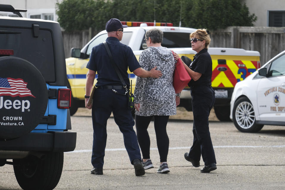A woman is comforted by a member of the Ventura County Fire department at U.S. Coast Guard Station Channel Islands in Oxnard, Calif., Monday, Sept. 2, 2019. Multiple people are feared dead after a dive boat caught fire before dawn Monday off the Southern California coast, according to the Coast Guard. (AP Photo/Ringo H.W. Chiu)