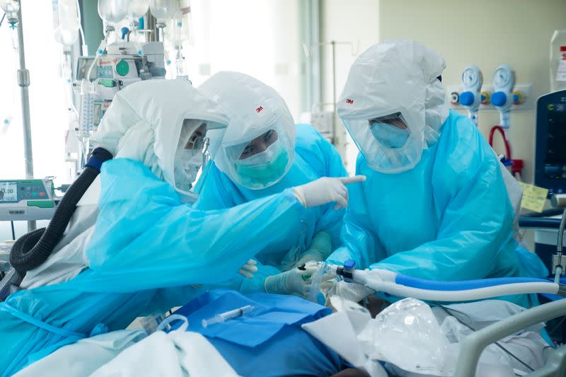 Medical workers take care of the coronavirus disease (COVID-19) patients in the ICU room in Bangkok