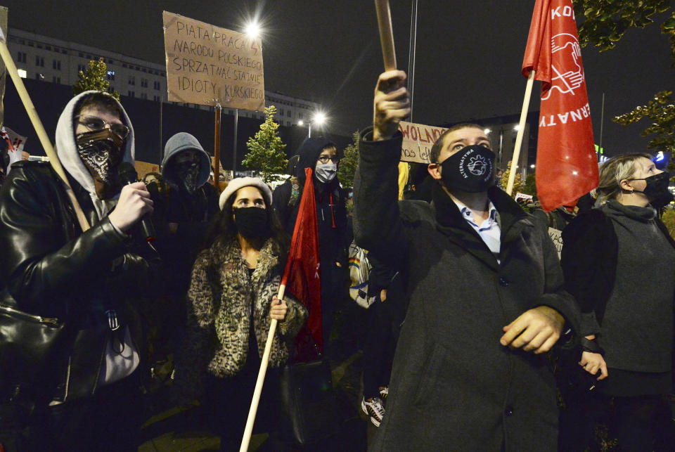 Protesters gathered before Poland's state TVP building with angry chants against the government on the eighth straight day of demonstrations against a court ruling that further tightened the predominantly Catholic nation's restrictive abortion law in Warsaw, Poland, Thursday, Oct. 29, 2020. A massive protest is planned for Friday, despite calls by the prime minister for no gatherings at the time of a steep spike in new COVID-19 infection cases.(AP Photo/Czarek Sokolowski)