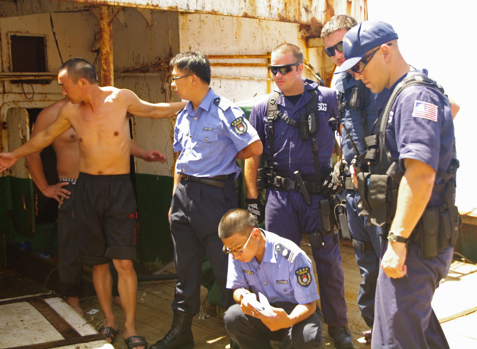 In this photo taken Saturday Aug. 11, 2012 and released by the U.S. Coast Guard, crewmembers from the Coast Guard cutter Rush and the China Fishery Law Enforcement Command review and inspect the suspected high seas drift net fishing vessel Da Cheng in the North Pacific Ocean. The U.S. Coast Guard has transferred to China a vessel suspected of illegal high seas driftnet fishing that was pursued by a cutter assigned to Alaska. Coast Guard officials say the 177-foot Da Cheng seized 850 miles east of Tokyo last week was turned over Tuesday to the China Fishery Law Enforcement Command. The Hawaii-based Coast Guard cutter Rush escorted the stateless vessel. (AP Photo/U.S. Coast Guard)