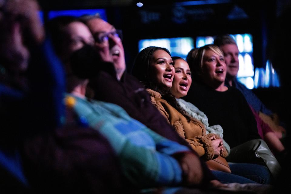 Audience members laugh as they watch drag star Latrice Royale perform Wednesday, Dec. 13, 2023, at Wooly's in Des Moines.