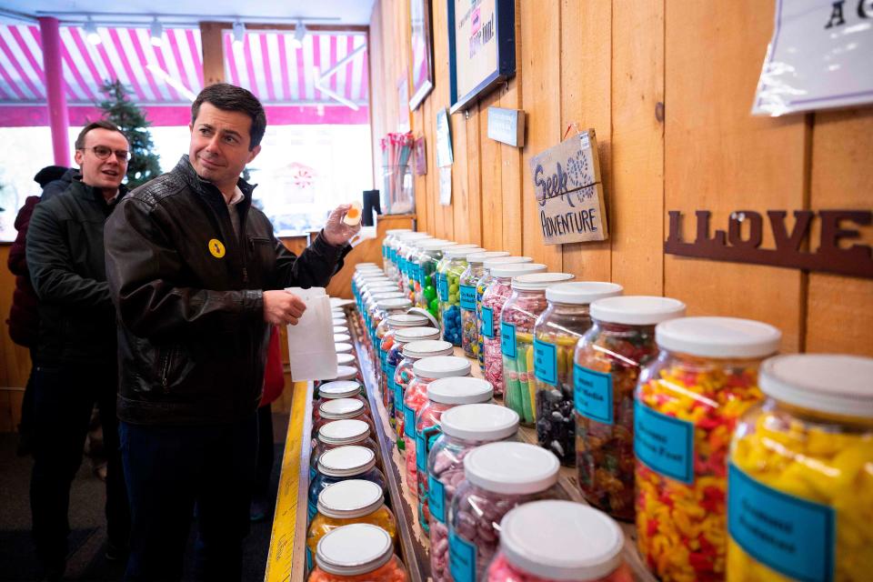 Democratic presidential hopeful Mayor Pete Buttigieg holds up a candy egg as he visits Chutters candy shop in Littleton, NH, on November 10, 2019.