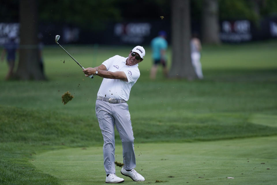 Phil Mickelson hits onto the 13th green during the second round of the Rocket Mortgage Classic golf tournament, Friday, July 2, 2021, at the Detroit Golf Club in Detroit. (AP Photo/Carlos Osorio)