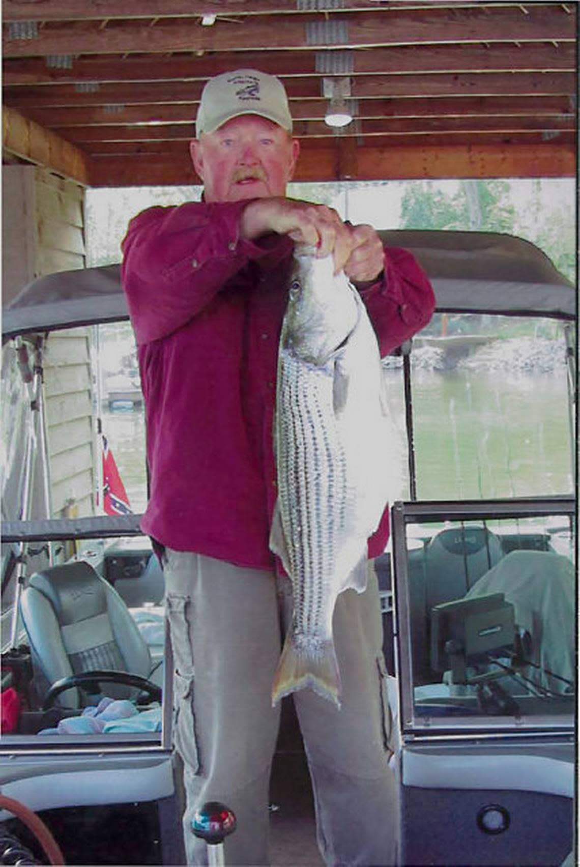 In this 2012 Charlotte Observer file photo, veteran Lake Norman fisherman Sam “Rawhide” Newman of Mooresville holds a 9-pound striper he caught on the lake.