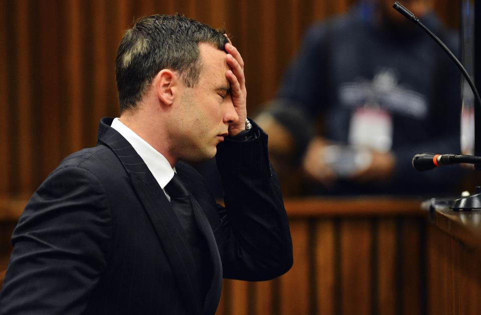South African Olympic and Paralympic athlete Oscar Pistorius reacts in the dock during his murder trial in the North Gauteng High Court in Pretoria June 30, 2014. Pistorius is on trial for murdering his girlfriend Reeva Steenkamp at his suburban Pretoria home on Valentine's Day last year. REUTERS/Phill Magakoe/Pool
