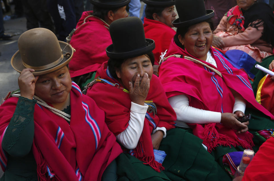 Aymara women, supporters of Bolivia's President Evo Morales, sit outside the presidential palace in La Paz, Bolivia, Thursday, Oct. 31, 2019. The women say they are keeping an eye out for anybody that might want to hurt President Morales. (AP Photo/Juan Karita)