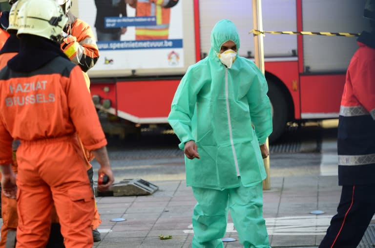 A person dressed in a protective suit is evacuated from Brussels Great Mosque and led to an ambulance, on November 26, 2015